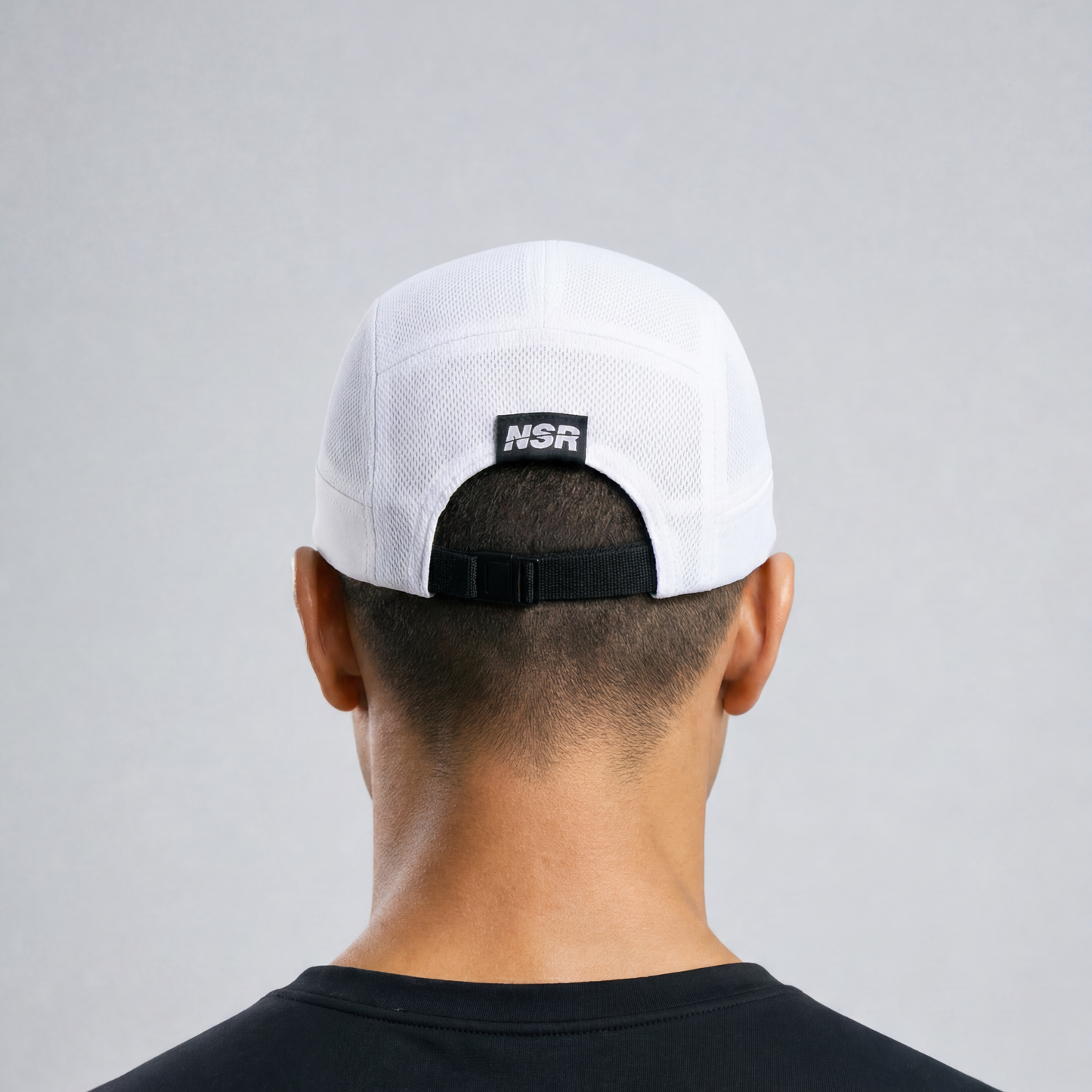 white cap with a logo on the back against a gray background