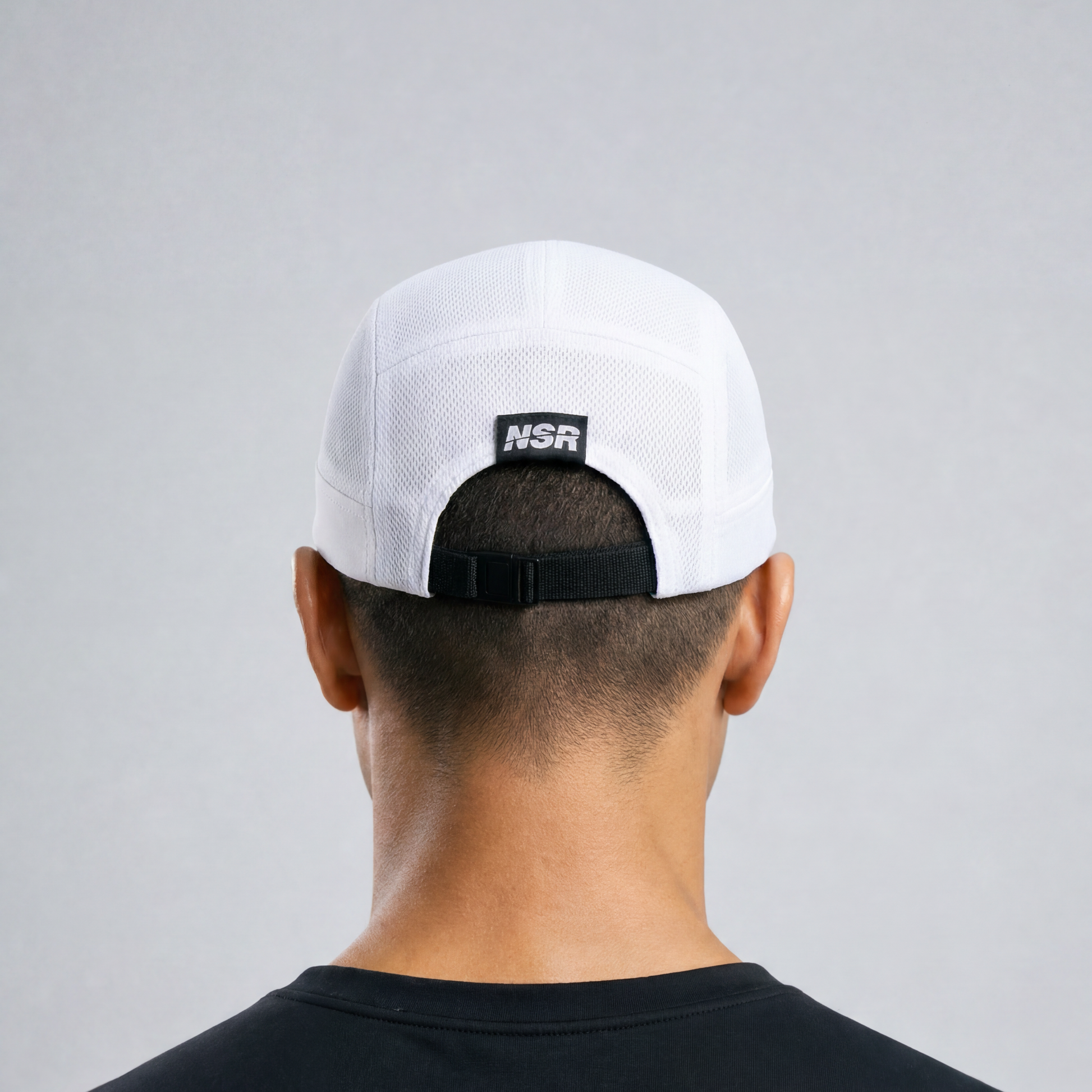white cap with a logo on the back against a gray background
